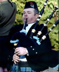 Our Pipe Major, John Low, playing the lament, Flowers of the Forest, at an annual Remembrance Day Parade in Helensburgh.