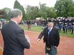 PM John Low receiving the award from Sir Malcolm Colquhoun for the best senior band on parade at the Helensburgh Bi-centennial Pipe Band Championships in 2011.