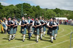 Approaching the dias for the opening ceremony of the 2012 Helensburgh Highland Games. This photo shows the two guest pipers from Lomond school who joined us for the parade to the venue.