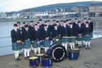 A band photo on Helensburgh pier in 2012. One of the last pictures of the band before being issued with new uniforms after the band renaming to the Clan Colquhoun Pipe Band in 2013. I seem to remember it was freezing cold that day!