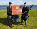 PM John Low receiving a commemorative plaque from Colina Helen Campbell of the Bi-Centenary Pipe Band Championships Committee on the occasion of the Centenary of the Band in 2013.